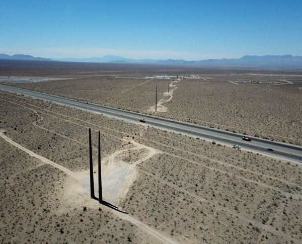 Transmission lines running across vast dry lands Transmission lines running across vast dry lands