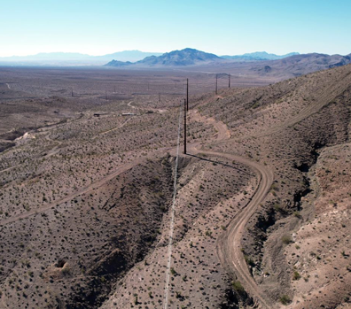 transmission lines cutting across desert mountains
